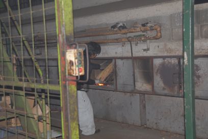 横型炉の燻製機への雑木の投入